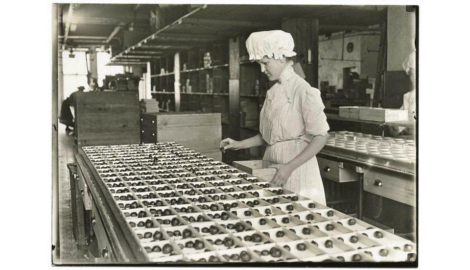 Huyler's factory worker packing chocolates on the production line