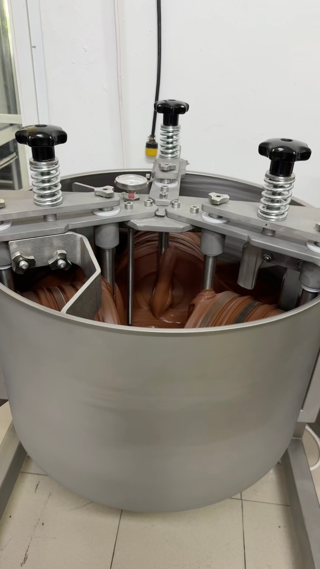 Industrial chocolate mixing vat equipment at the Huyler's factory